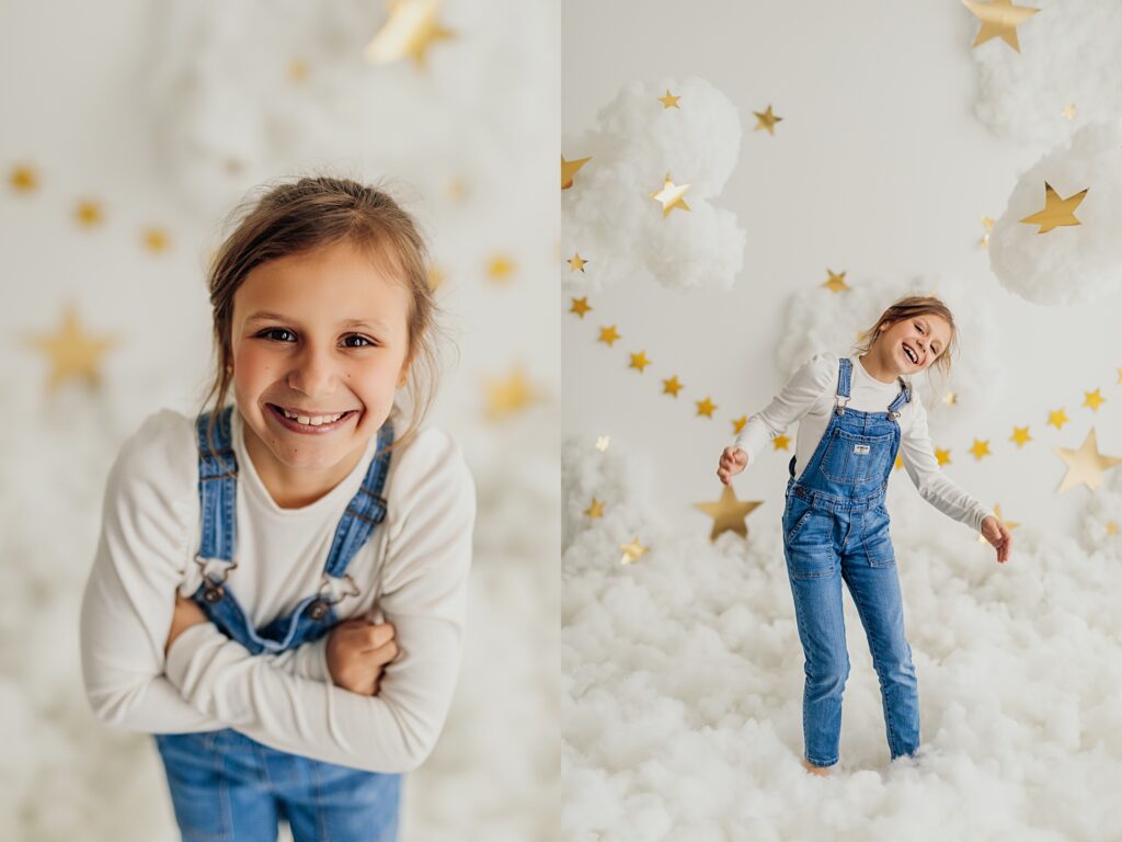 A young girl poses amidst the clouds in a whimsical studio mini session