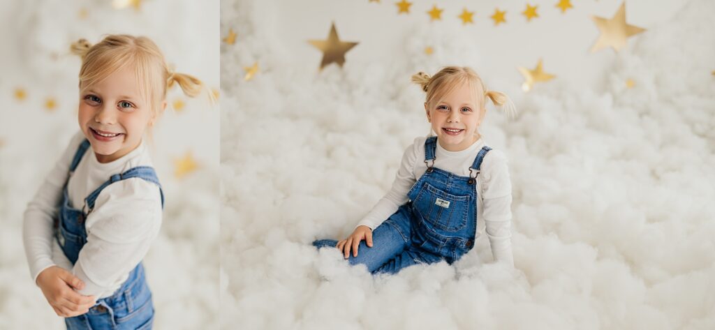 A young girl poses amidst the clouds in a whimsical studio mini session