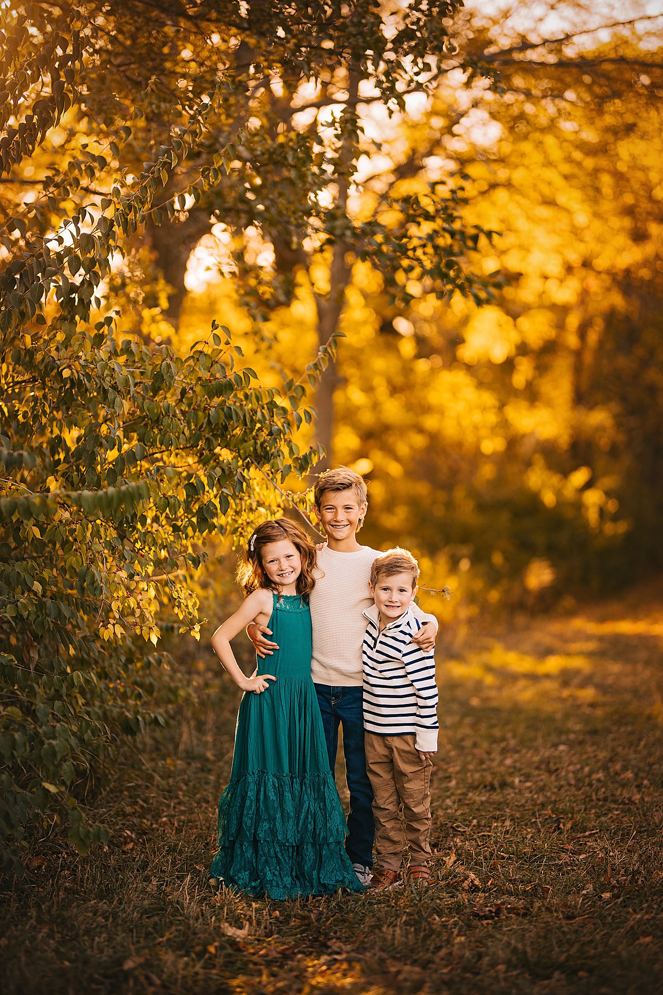 siblings hug together for a sweet photo at their family photo session