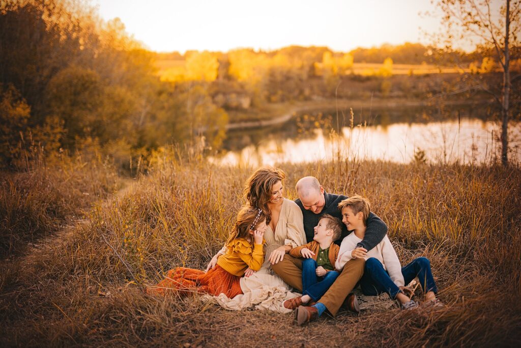 A family shares a candid moment together at sunset on the edge of a quarry