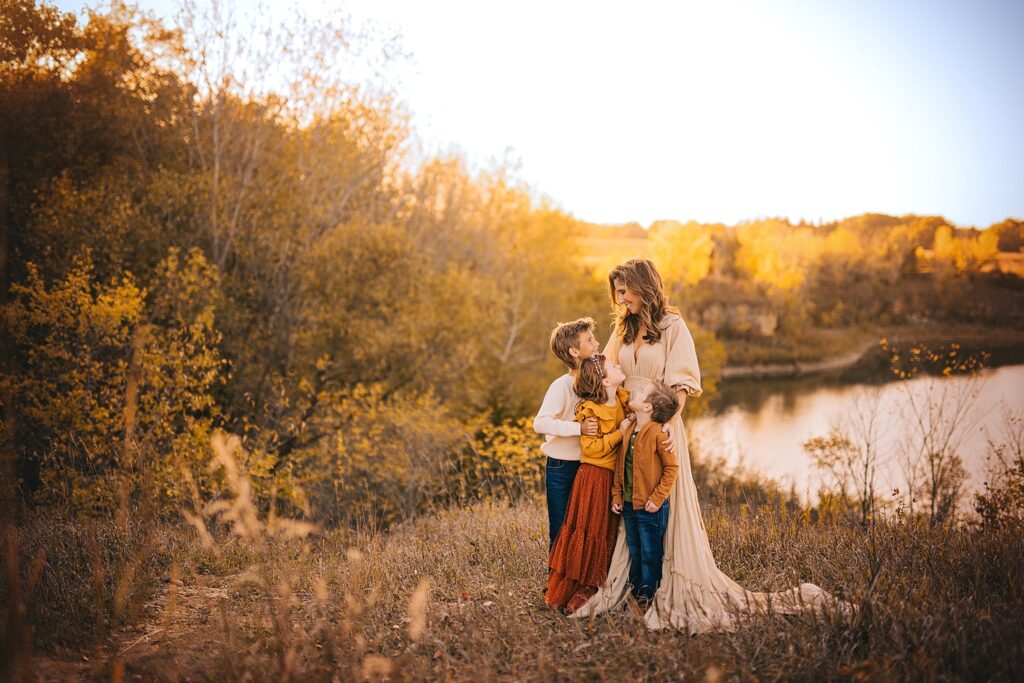 a mother shares a candid moment together at sunset on the edge of a quarry