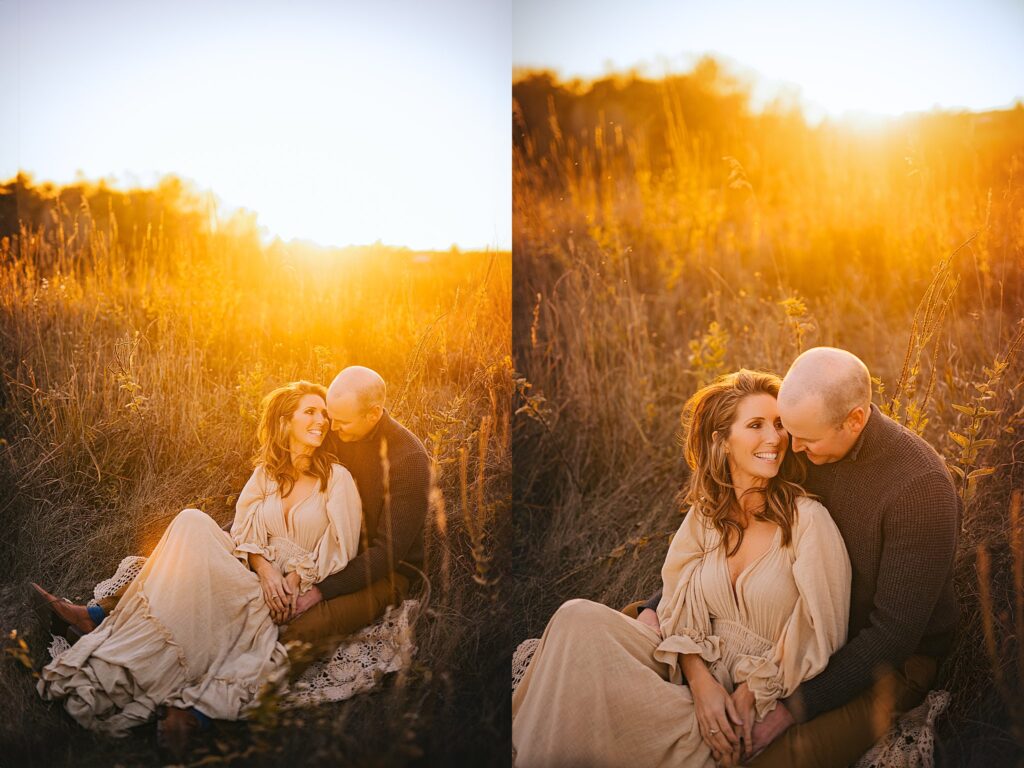a mom and dad snuggle together in the warmth of sunset at a family photo session