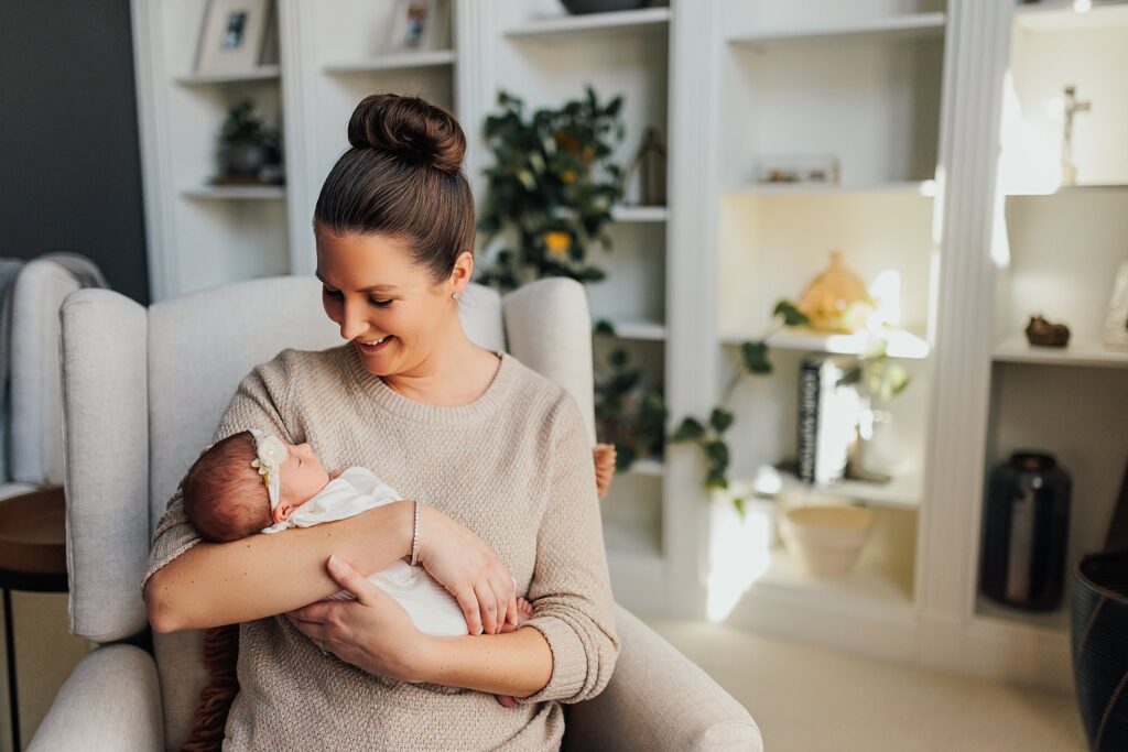 A mother enjoys tender moments with their newborn in the comfort of their home