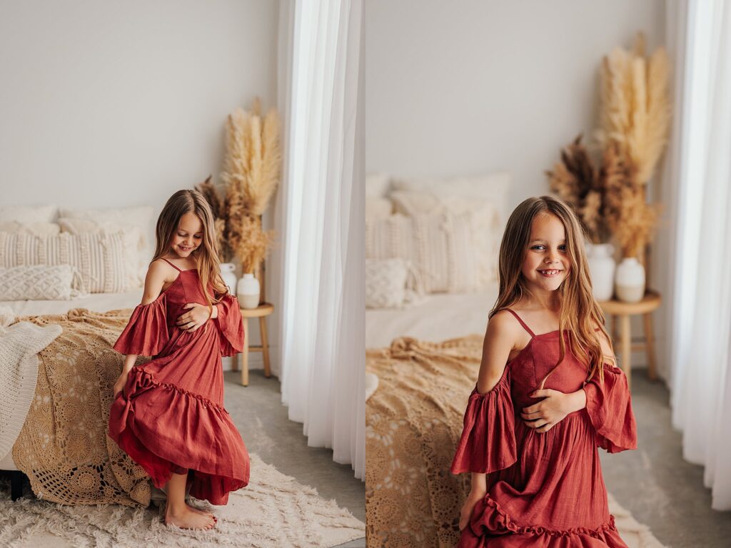 Portrait of a young girl smiling during a motherhood photography session in a Cedar Falls, Iowa studio.