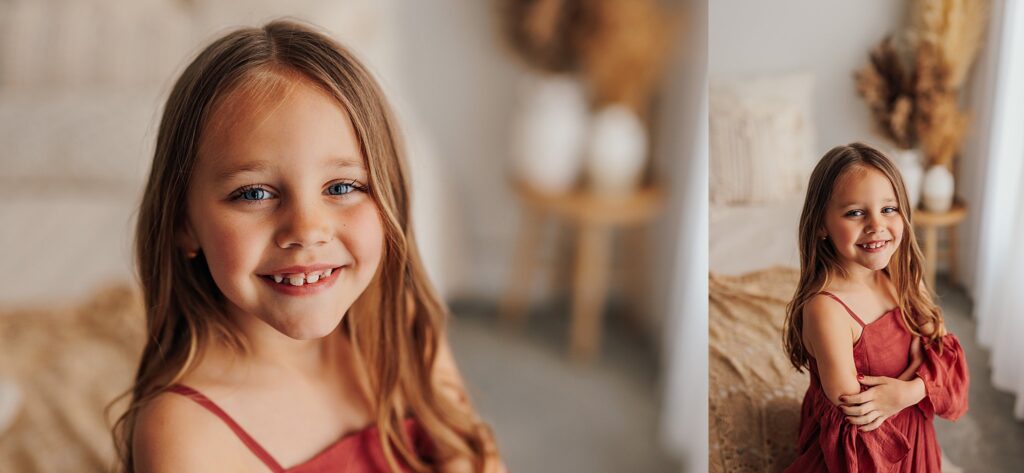 Portrait of a young girl smiling during a motherhood photography session in a Cedar Falls, Iowa studio.