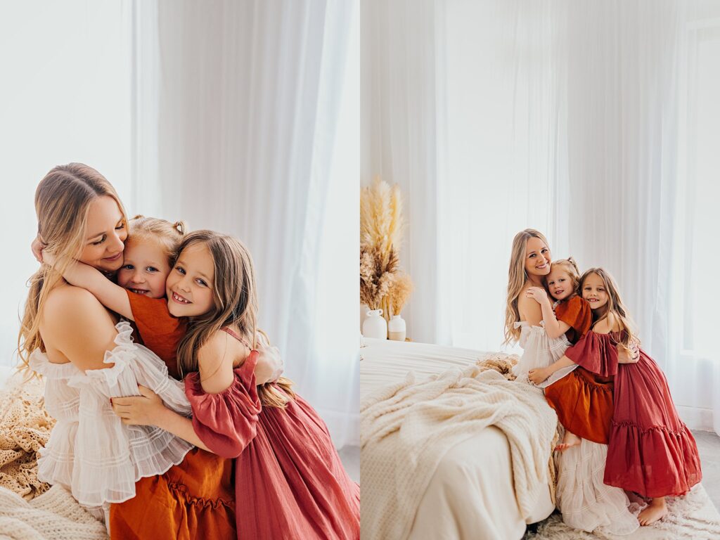 Mother and her two daughters sharing sweet moments during a Mommy and Me session in a Cedar Falls, Iowa studio