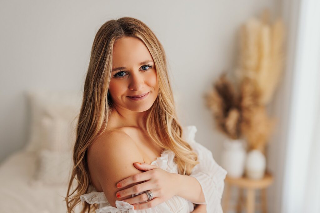 a photo of a mom on her own, smiling, at a motherhood session