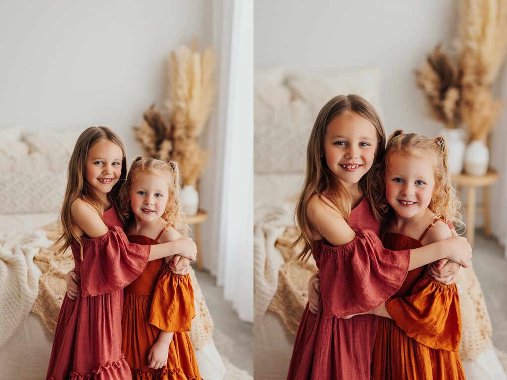 Beautiful sibling portrait of two sisters smiling together during a family photography session