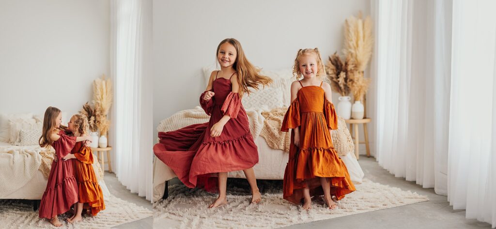 Beautiful sibling portrait of two sisters smiling together during a family photography session dancing