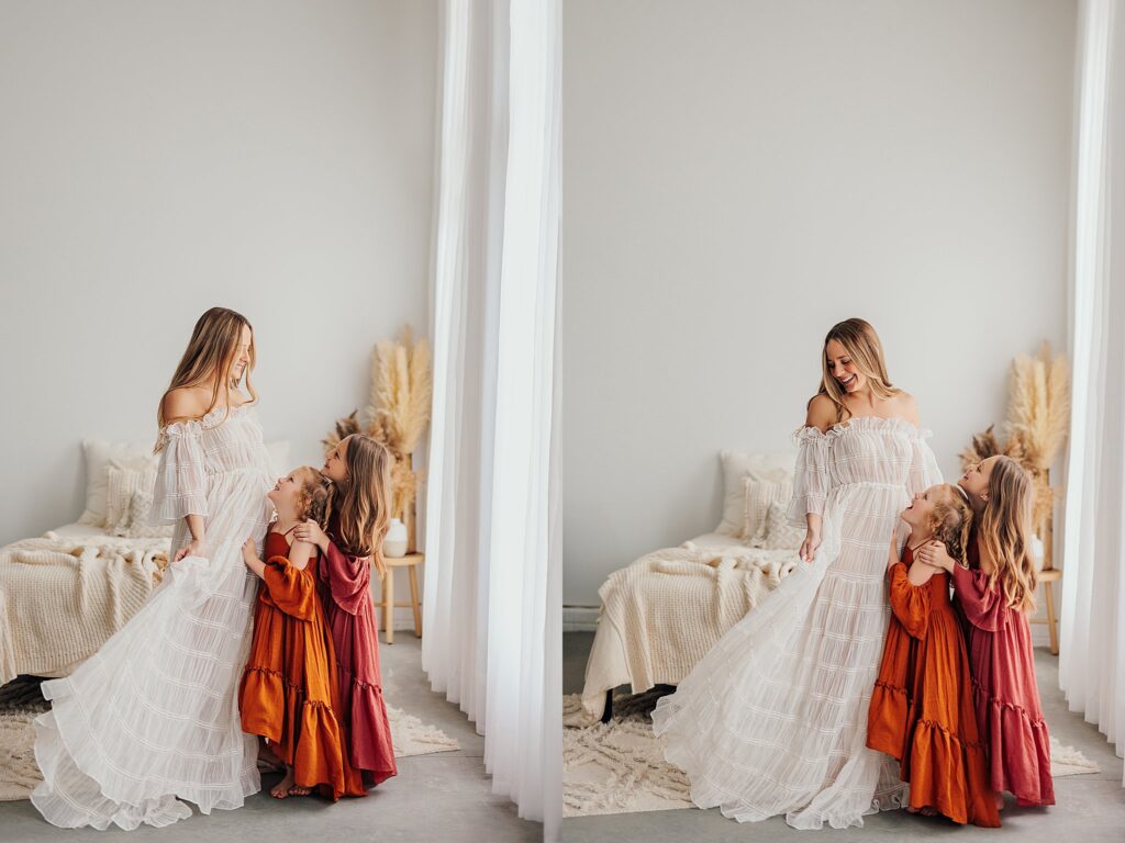 Mother and her two daughters sharing sweet moments during a Mommy and Me session in a Cedar Falls, Iowa studio