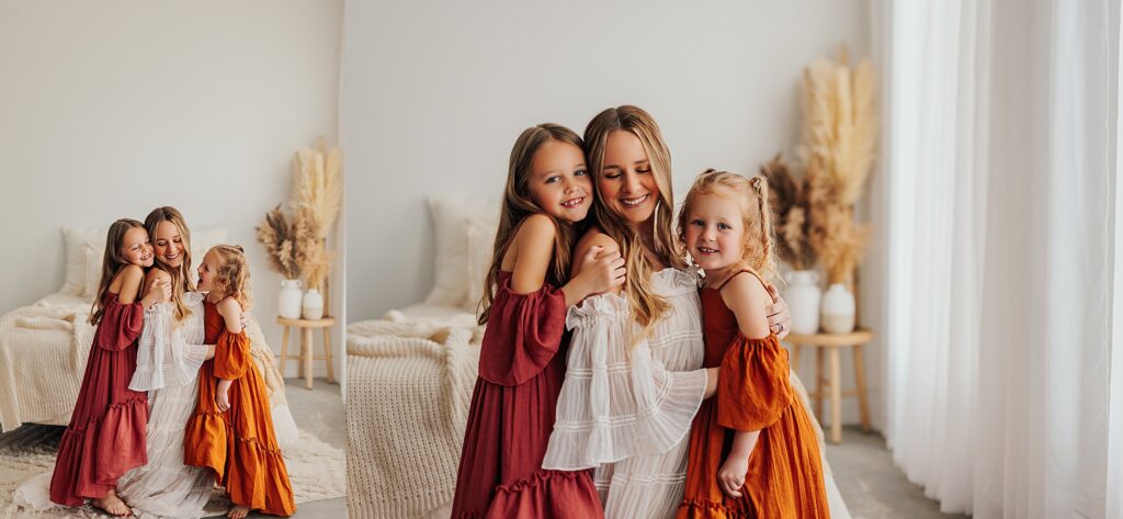 Mother and her two daughters sharing sweet moments during a Mommy and Me session in a Cedar Falls, Iowa studio