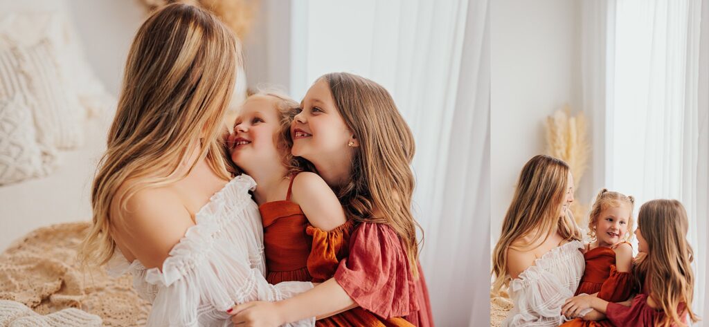 Mother and her two daughters sharing sweet moments during a Mommy and Me session in a Cedar Falls, Iowa studio