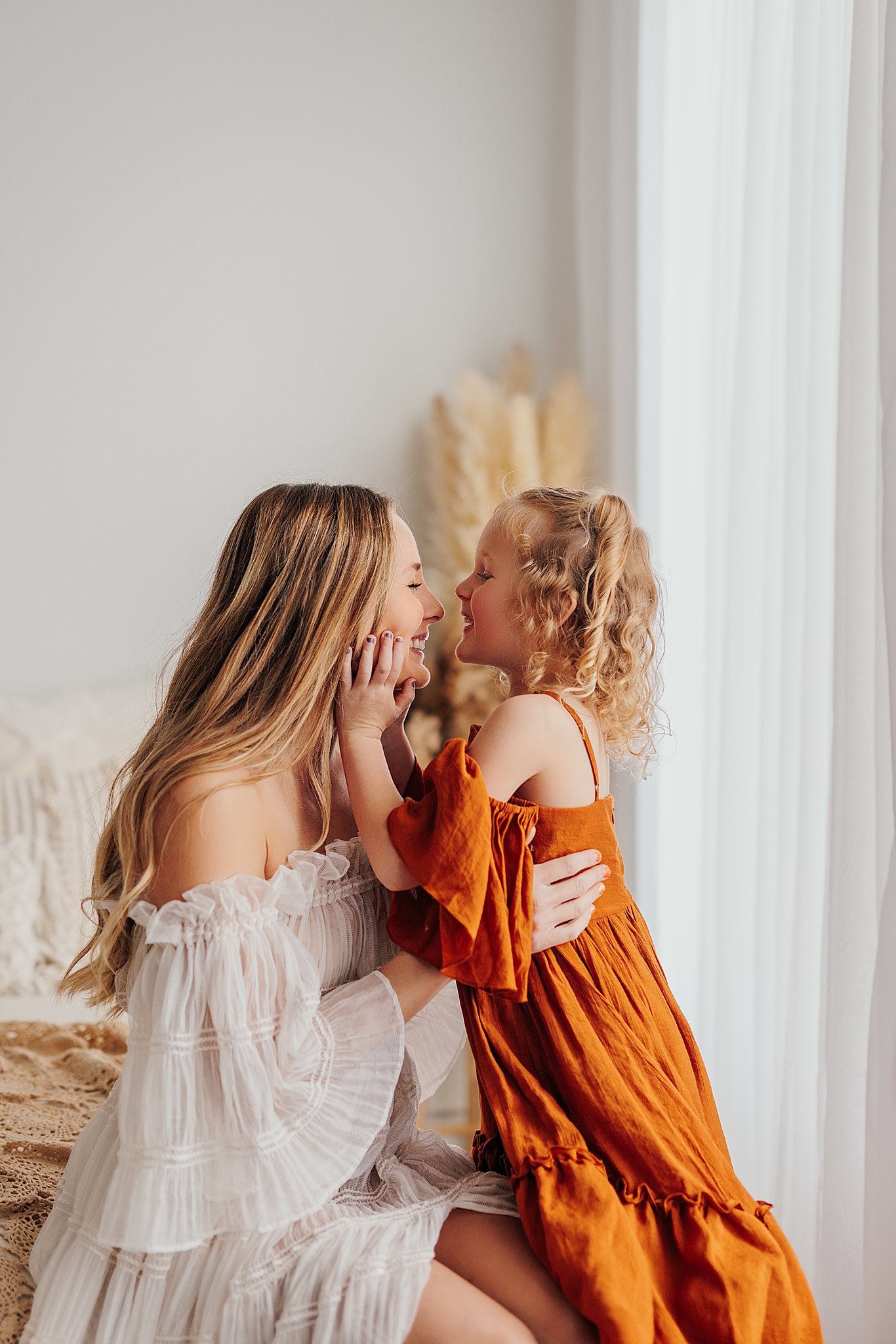 Tender moment between a mother and her daughters, with a mix of solo and sibling shots in a Cedar Falls, Iowa studio