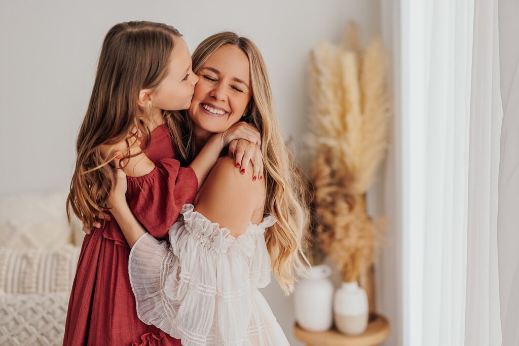 Tender moment between a mother and her daughters, with a mix of solo and sibling shots in a Cedar Falls, Iowa studio