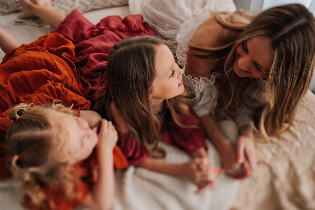 Tender moment between a mother and her daughters, with a mix of solo and sibling shots in a Cedar Falls, Iowa studio