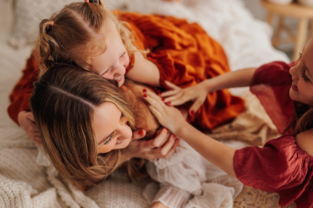 Tender moment between a mother and her daughters, with a mix of solo and sibling shots in a Cedar Falls, Iowa studio