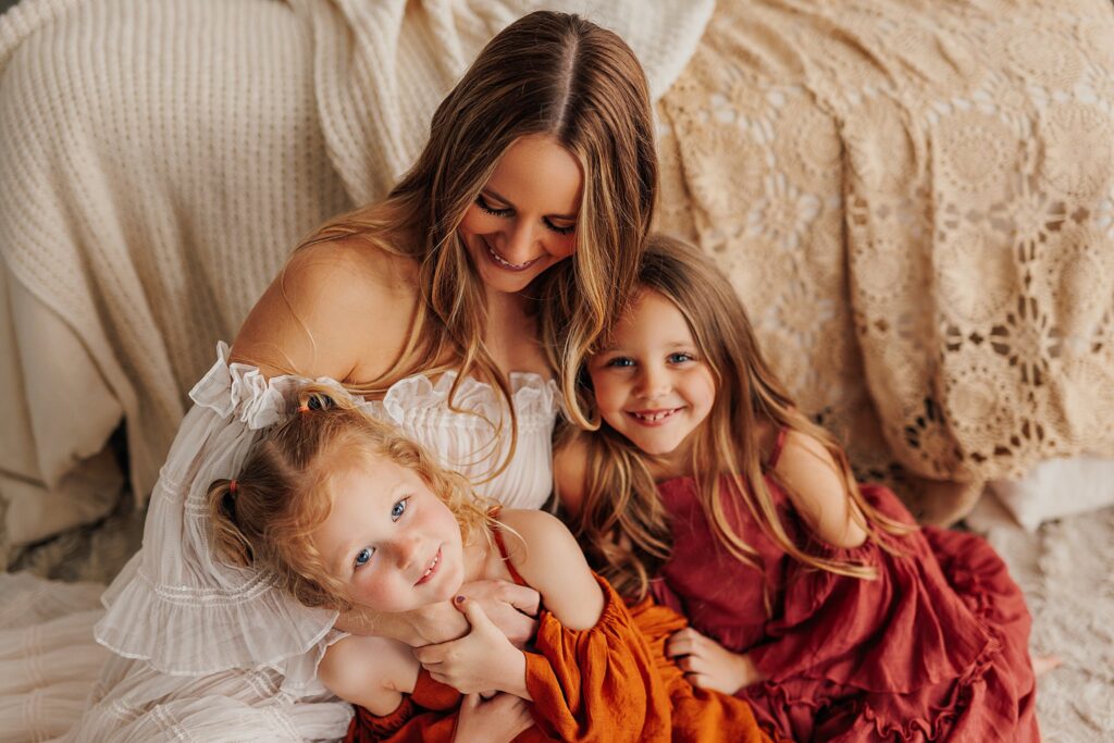 Tender moment between a mother and her daughters, with a mix of solo and sibling shots in a Cedar Falls, Iowa studio