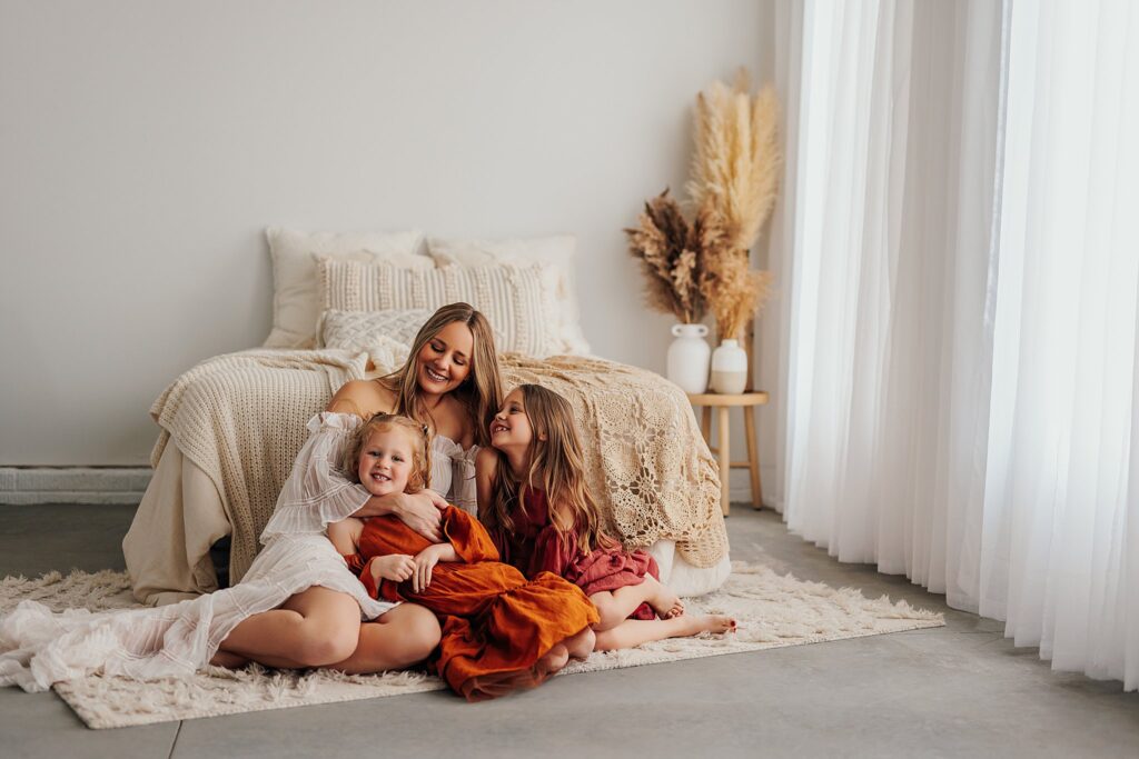 Tender moment between a mother and her daughters, with a mix of solo and sibling shots in a Cedar Falls, Iowa studio