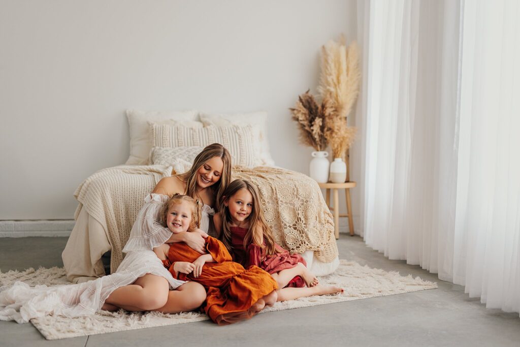 Tender moment between a mother and her daughters, with a mix of solo and sibling shots in a Cedar Falls, Iowa studio