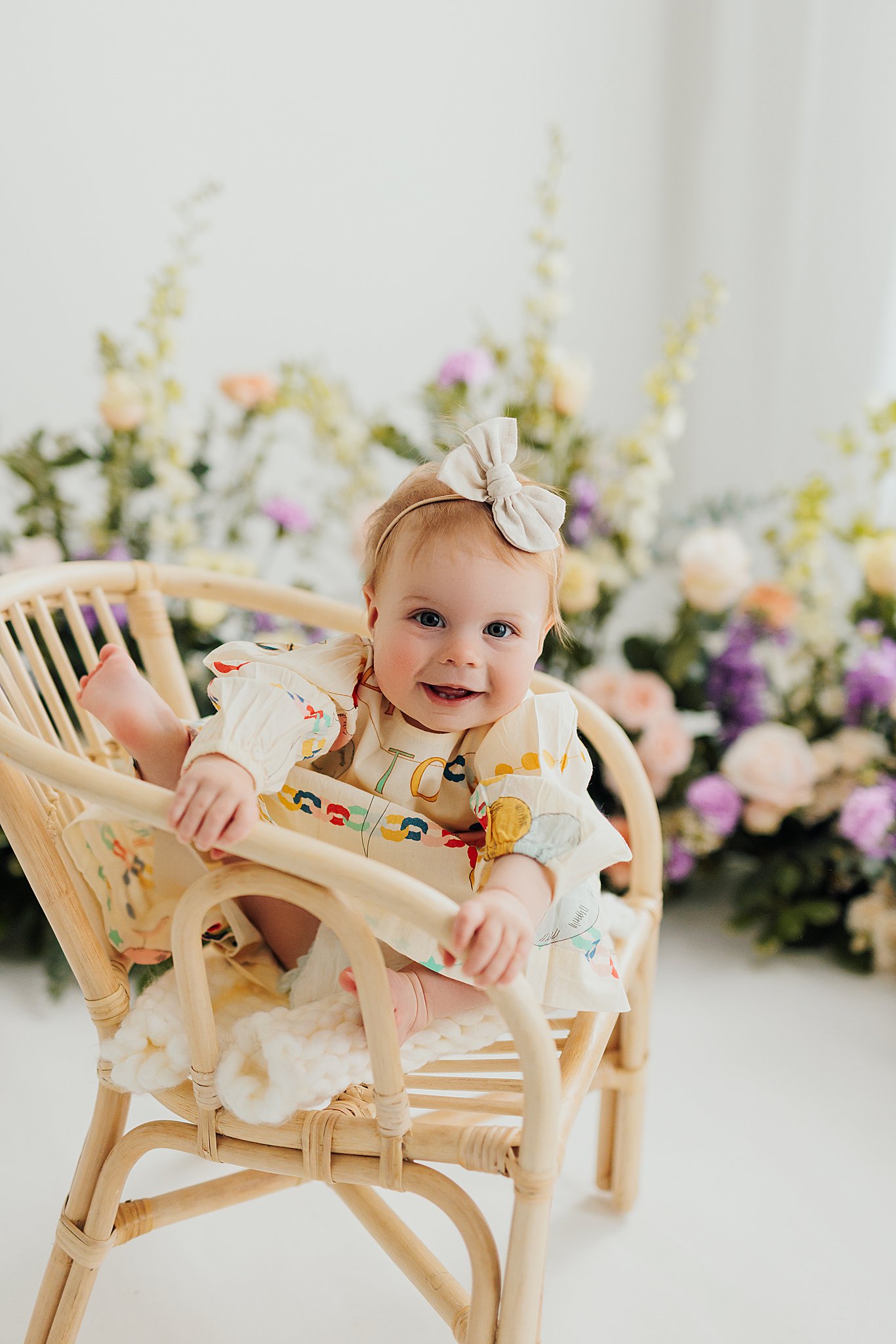 One-year-old baby with fresh florals in a Cedar Falls, Iowa photography studio