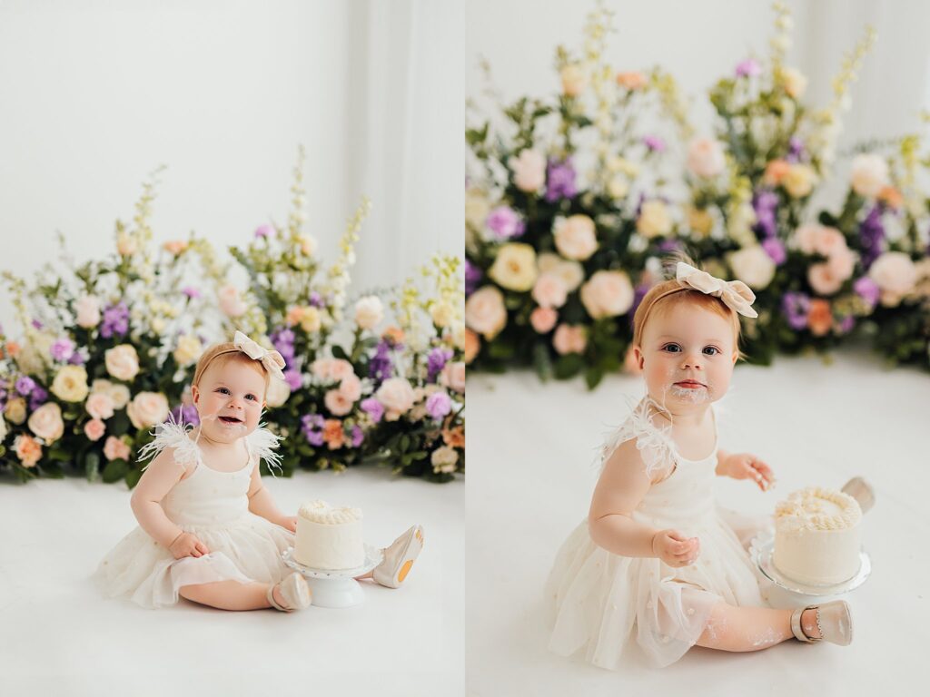 One-year-old baby enjoying a cake smash session with fresh florals in a Cedar Falls, Iowa photography studio