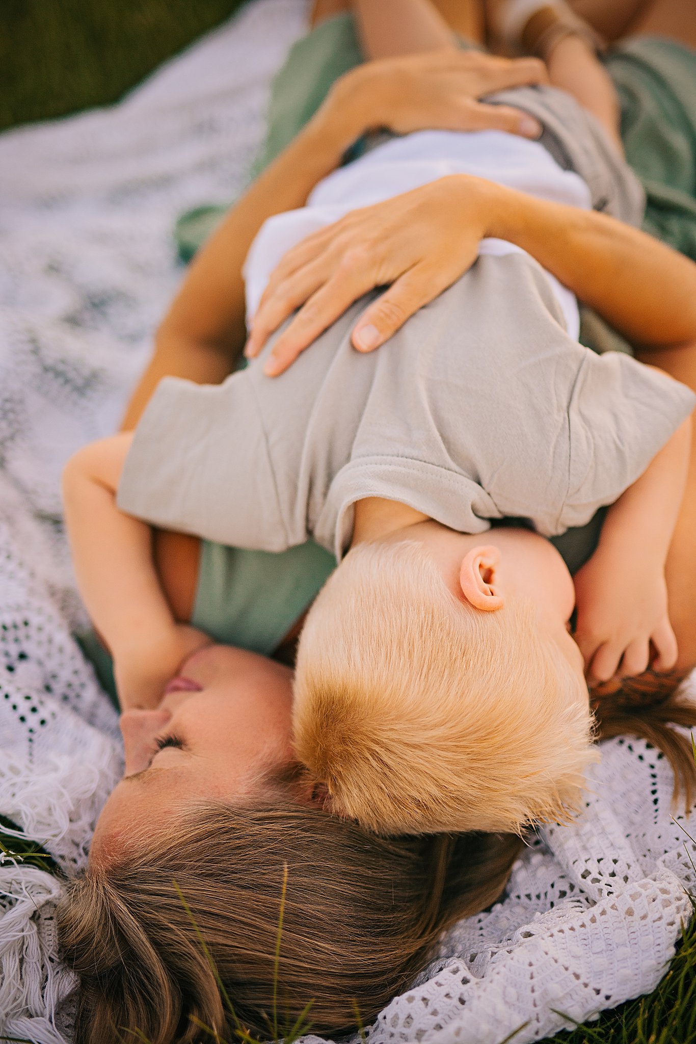 a small boy snuggles on his mother