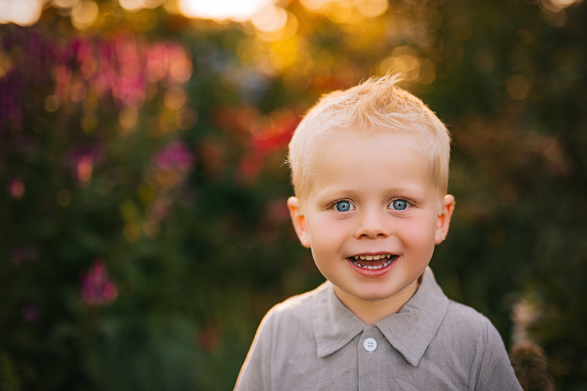 a boy smiling in wildflowers in cedar falls iowa